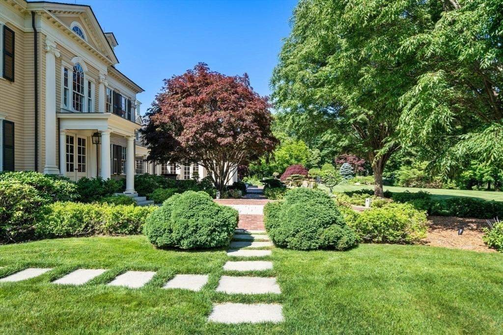 Manicured hedges, ground cover and a stepping-stone path at a New England estate
